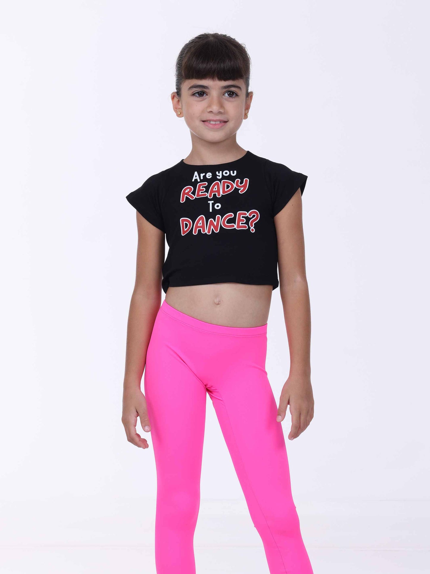 Child wearing a black crop top with 'Are you Ready to Dance?' text and pink leggings on a white background