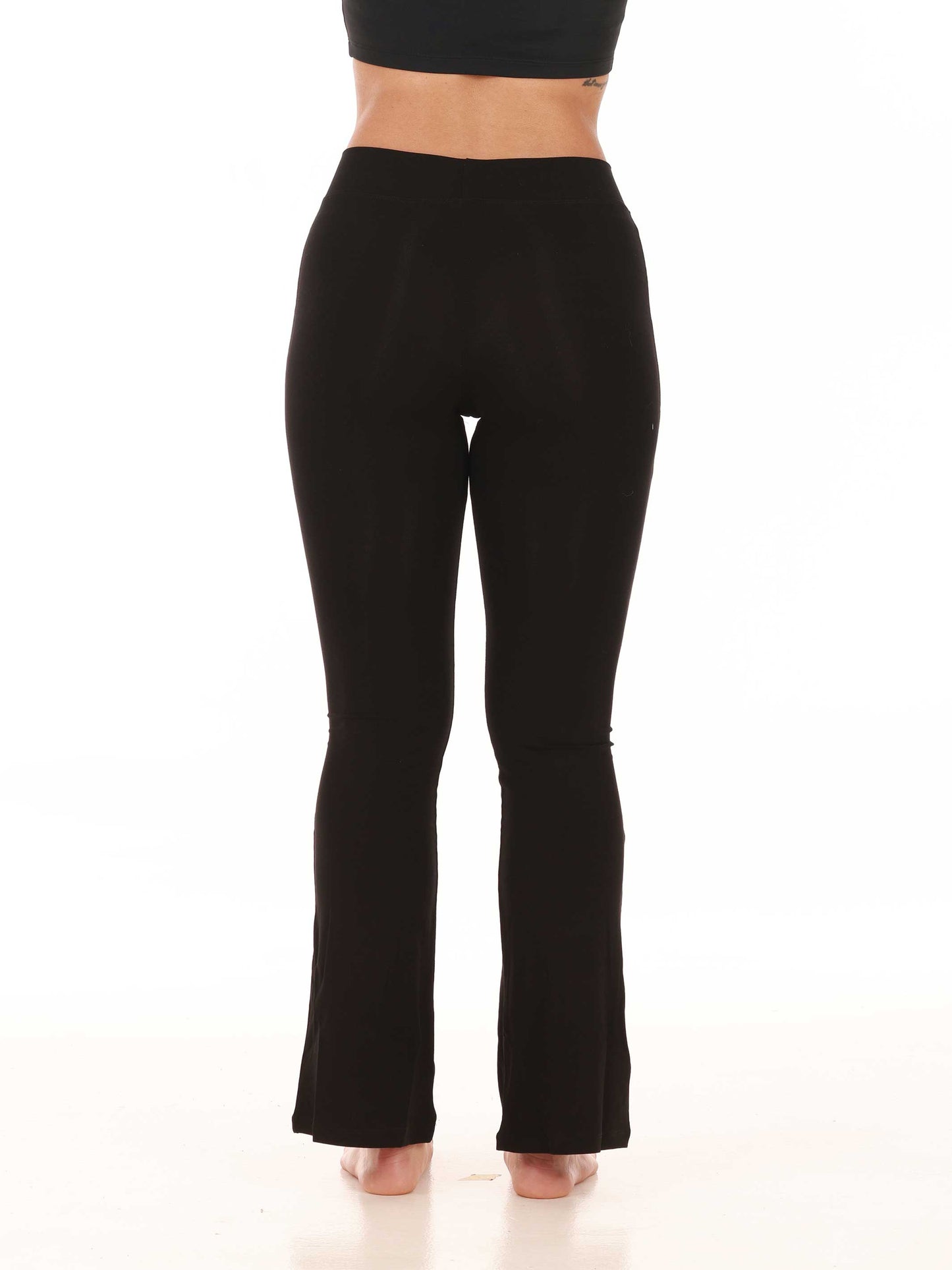 Black jazz pants worn by a person on a white background