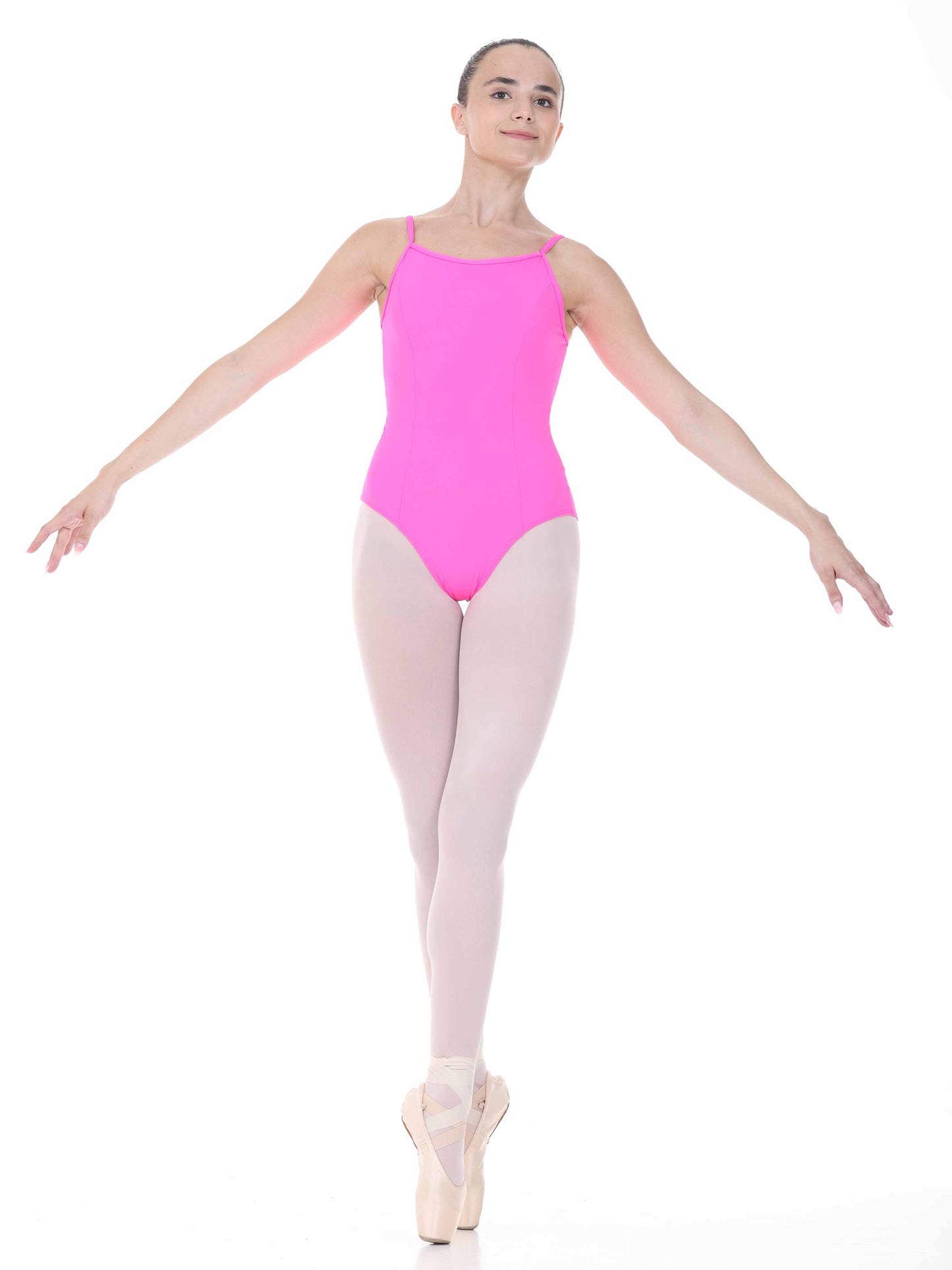 Ballerina in a bright fuchsia leotard and beige tights on a white background