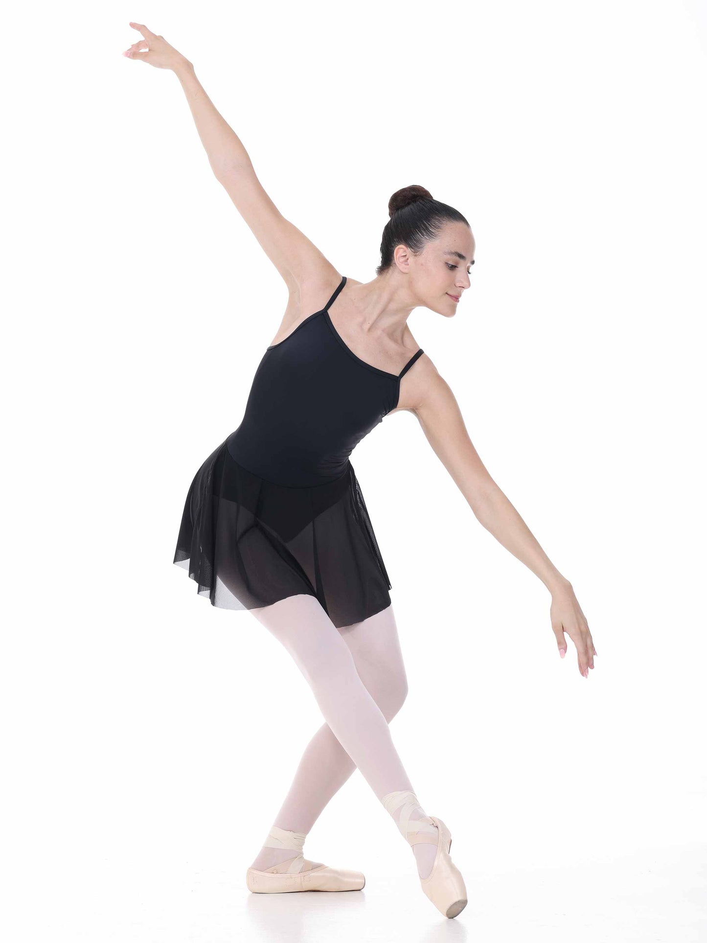 Ballerina in a black leotard and skirt on a white background