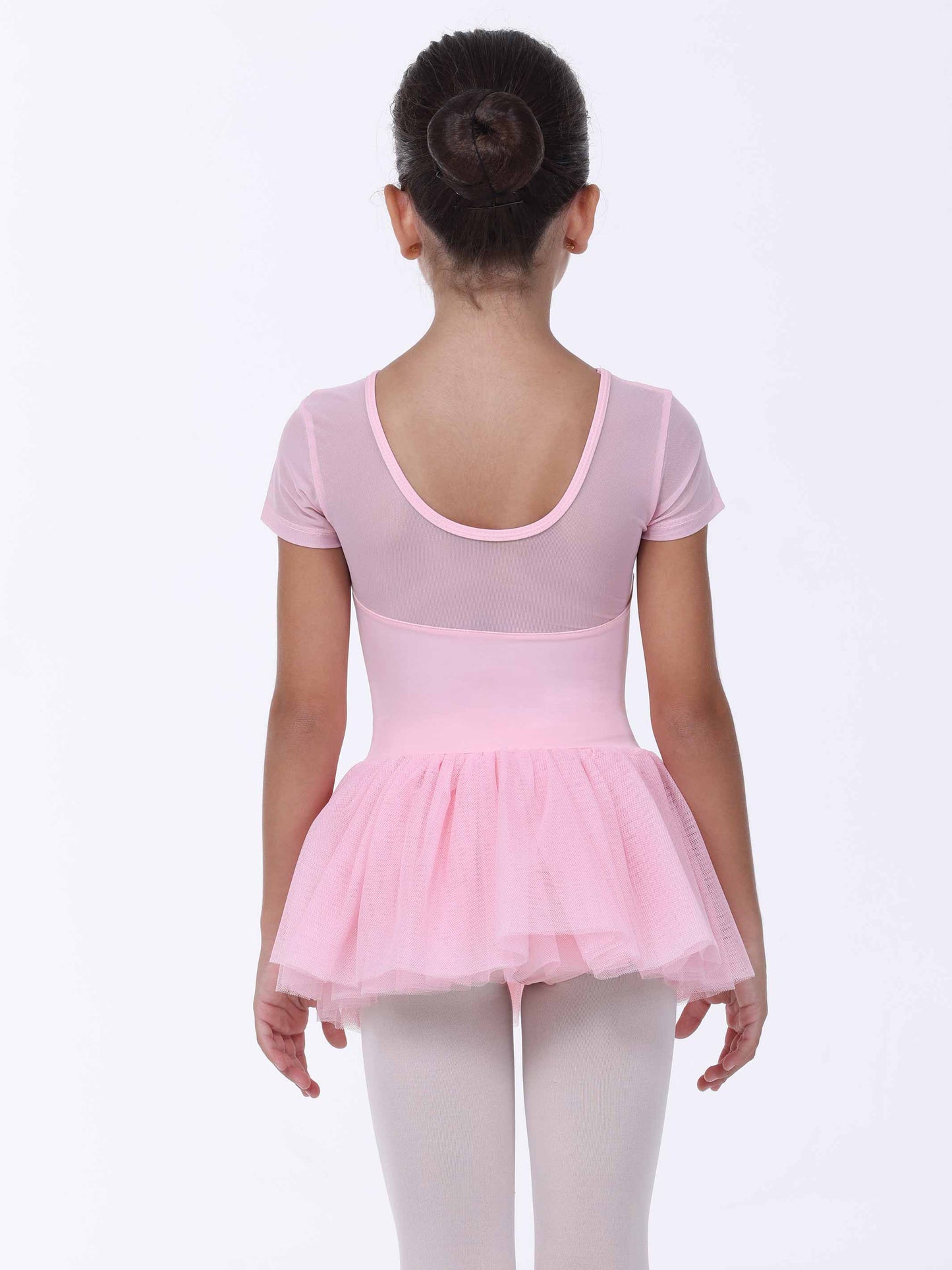Young girl wearing a pink ballet dress on a white background