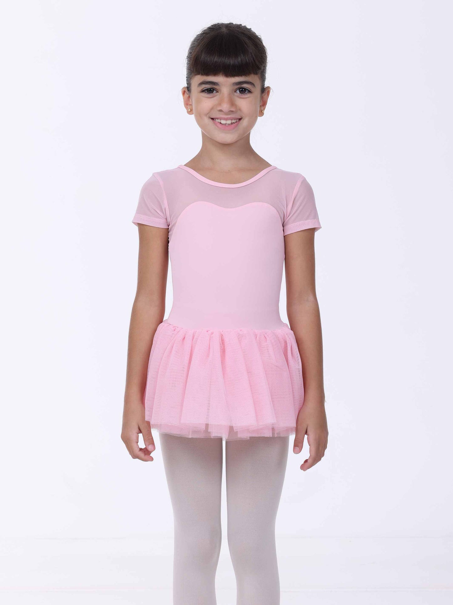 Young girl wearing a pink ballet outfit with a tutu on a white background