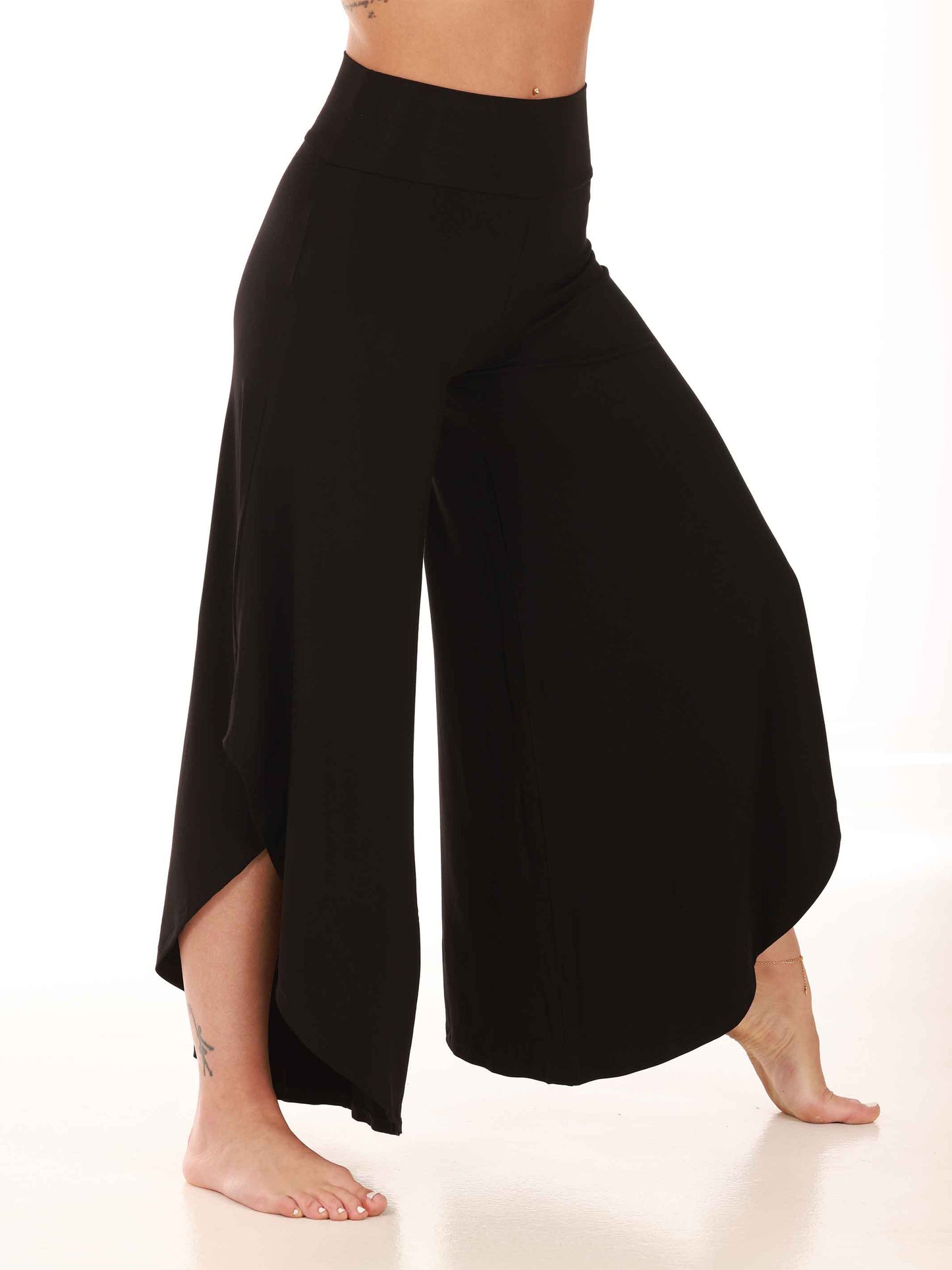 Black wide-leg pants worn by a person on a white background