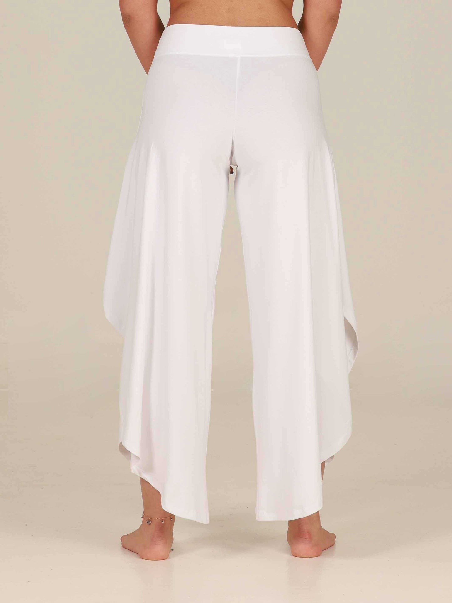 White wide-leg pants worn by a person on a beige background