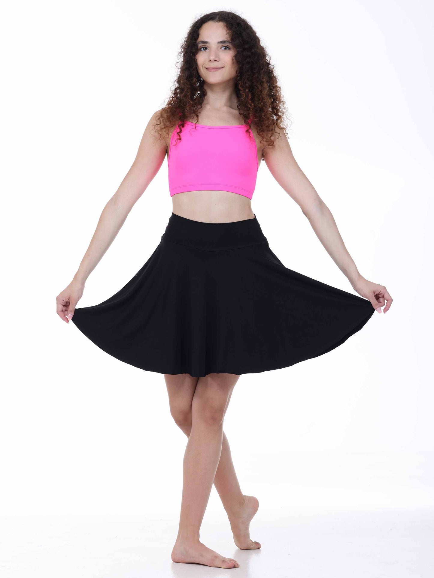 Woman wearing a pink top and black skirt on a white background