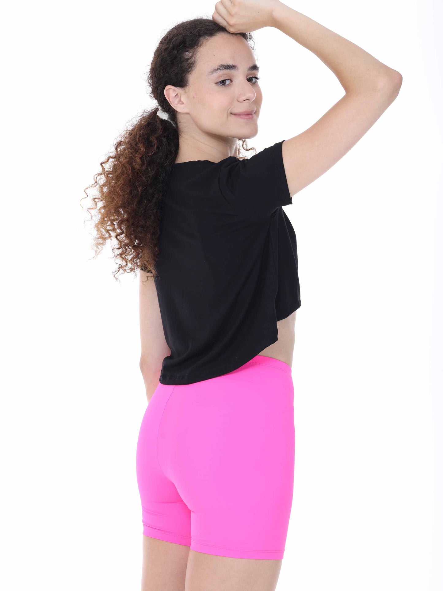 Person wearing a black top and pink shorts on a white background