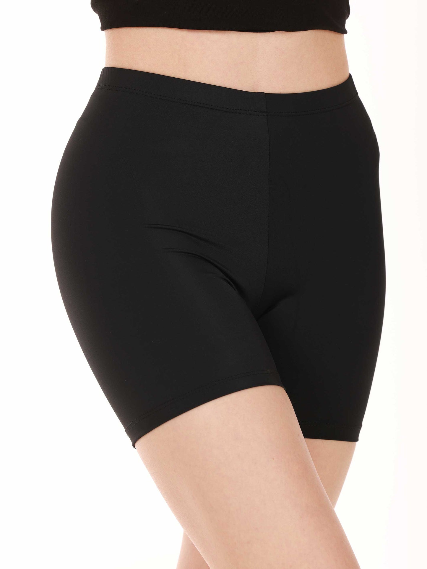 Black high-rise shorts worn by a person on a white background