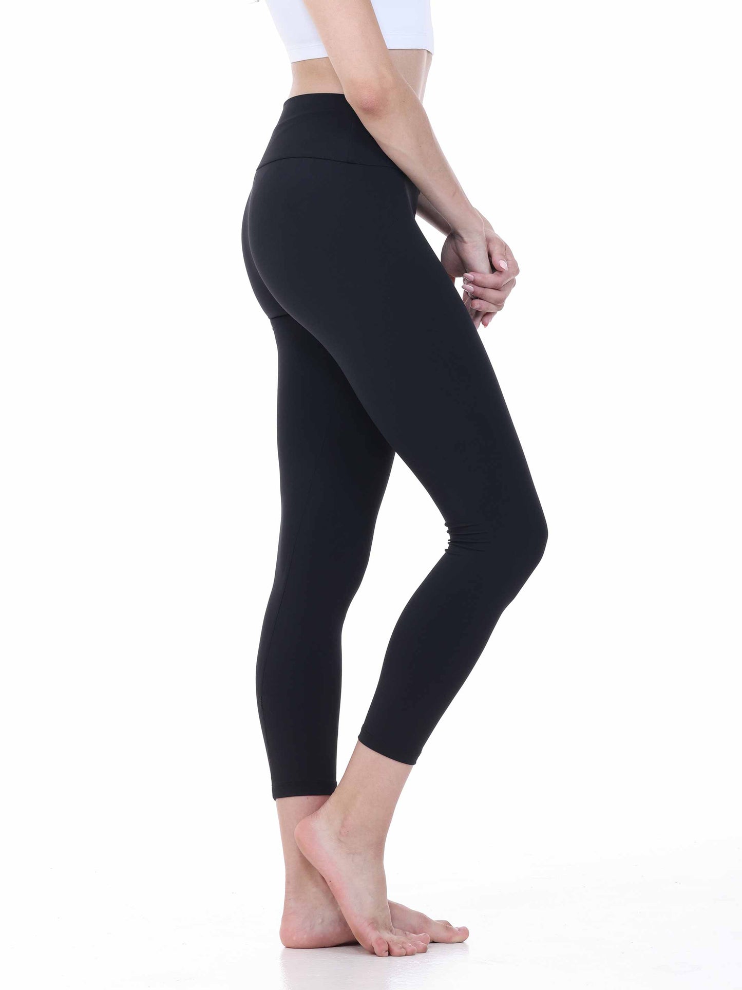Person wearing black leggings on a white background