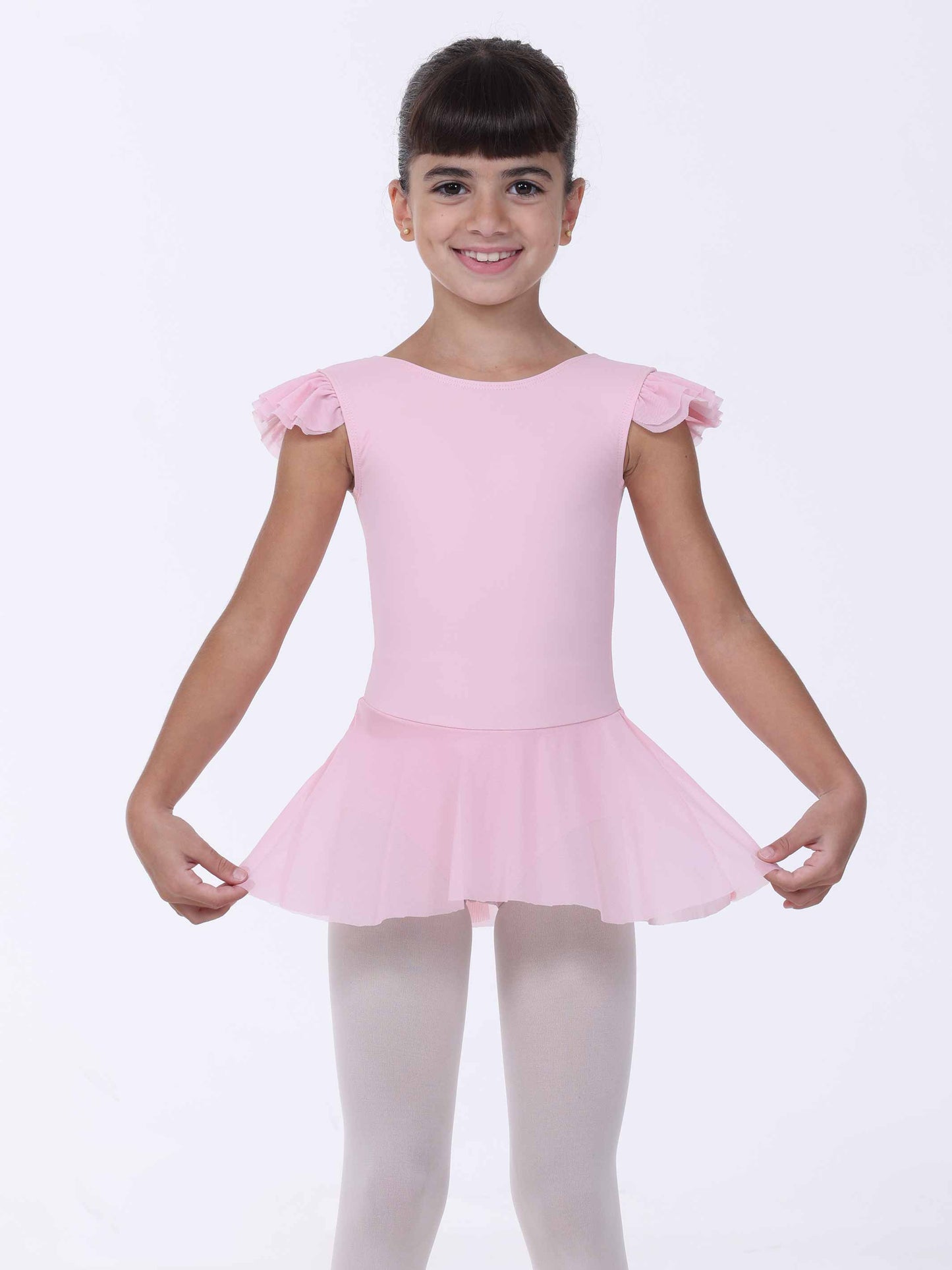 Young girl wearing a pink ballet dress with ruffled sleeves on a white background