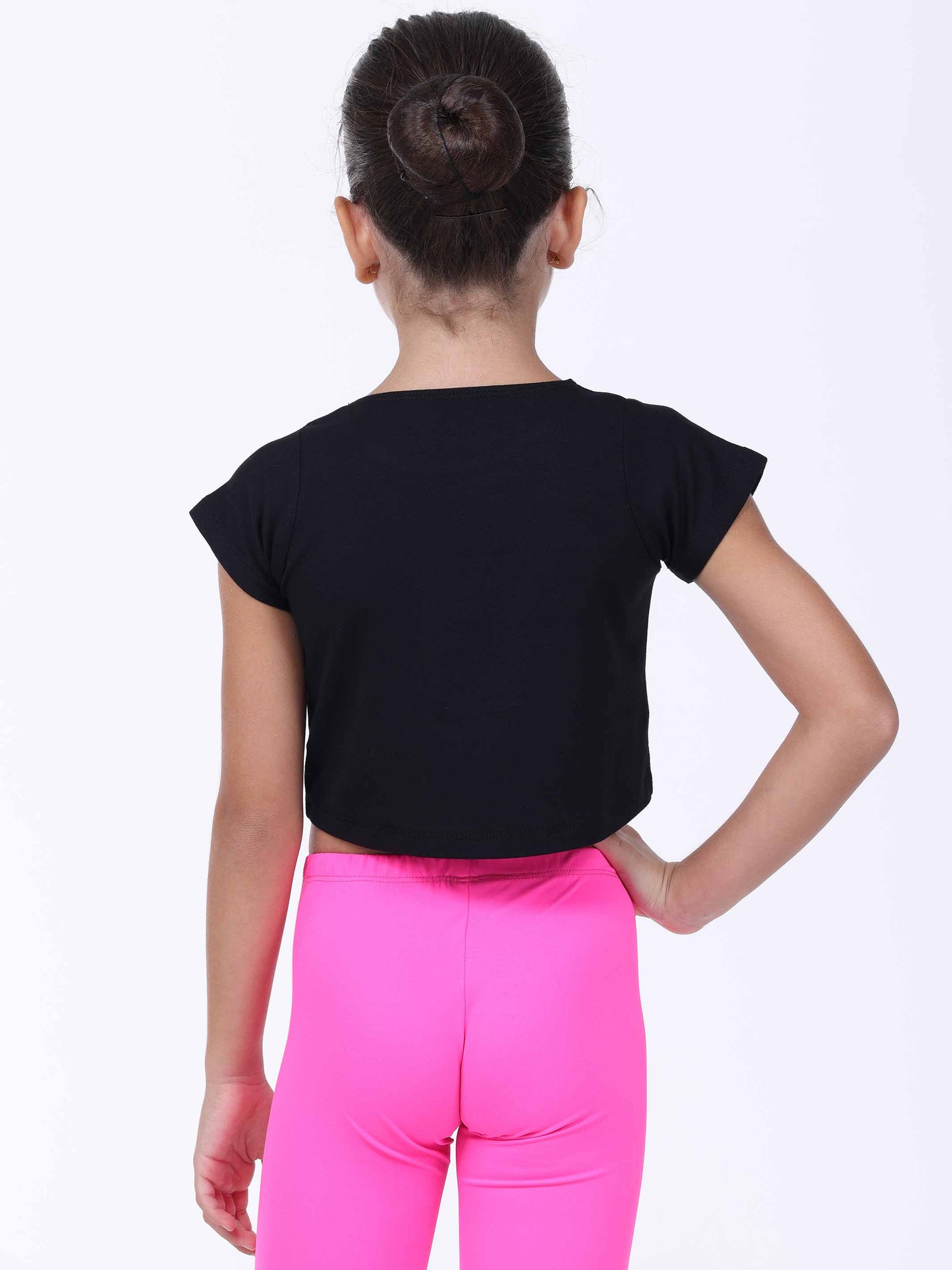 Person wearing a dance black top and pink pants on a white background