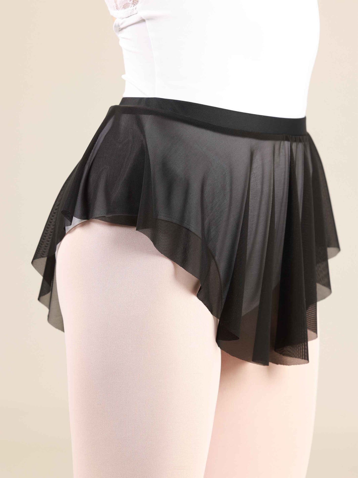 ballerina wearing an oval black ballet skirt with a white leotard