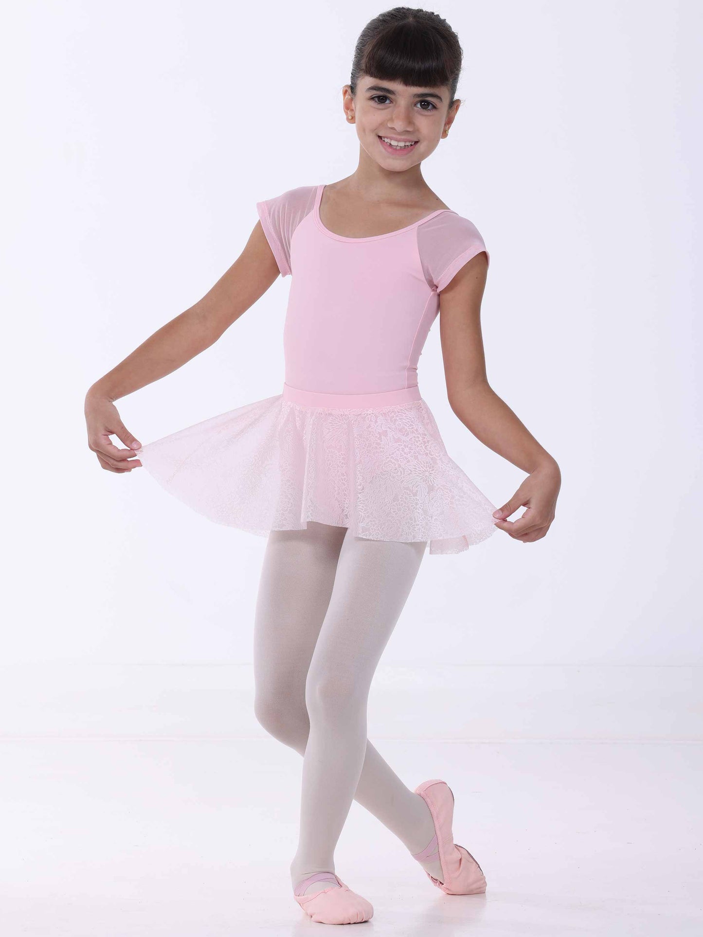 Young girl in a pink ballet outfit on a white background