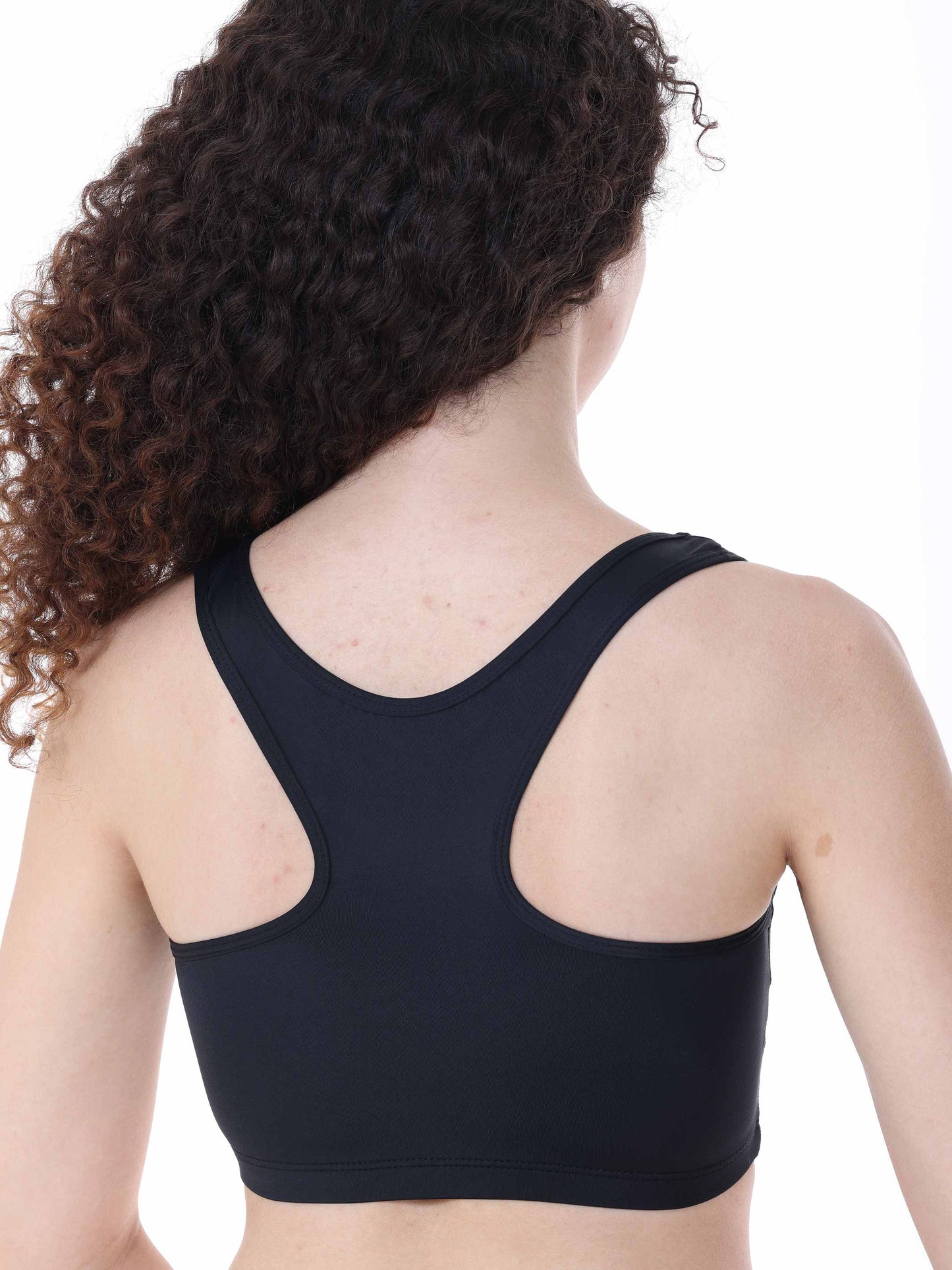 Person wearing a black sports bra on a white background