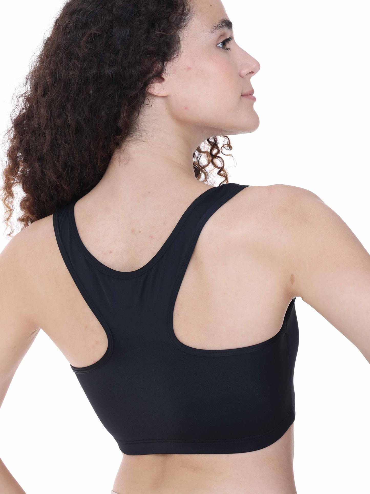 Woman wearing a black sports bra on a white background