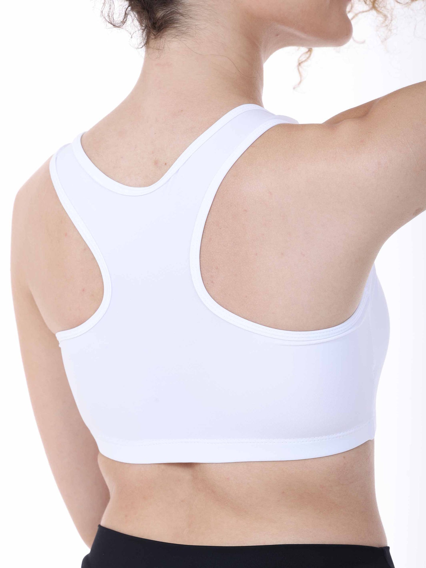 White sports bra worn by a person on a white background