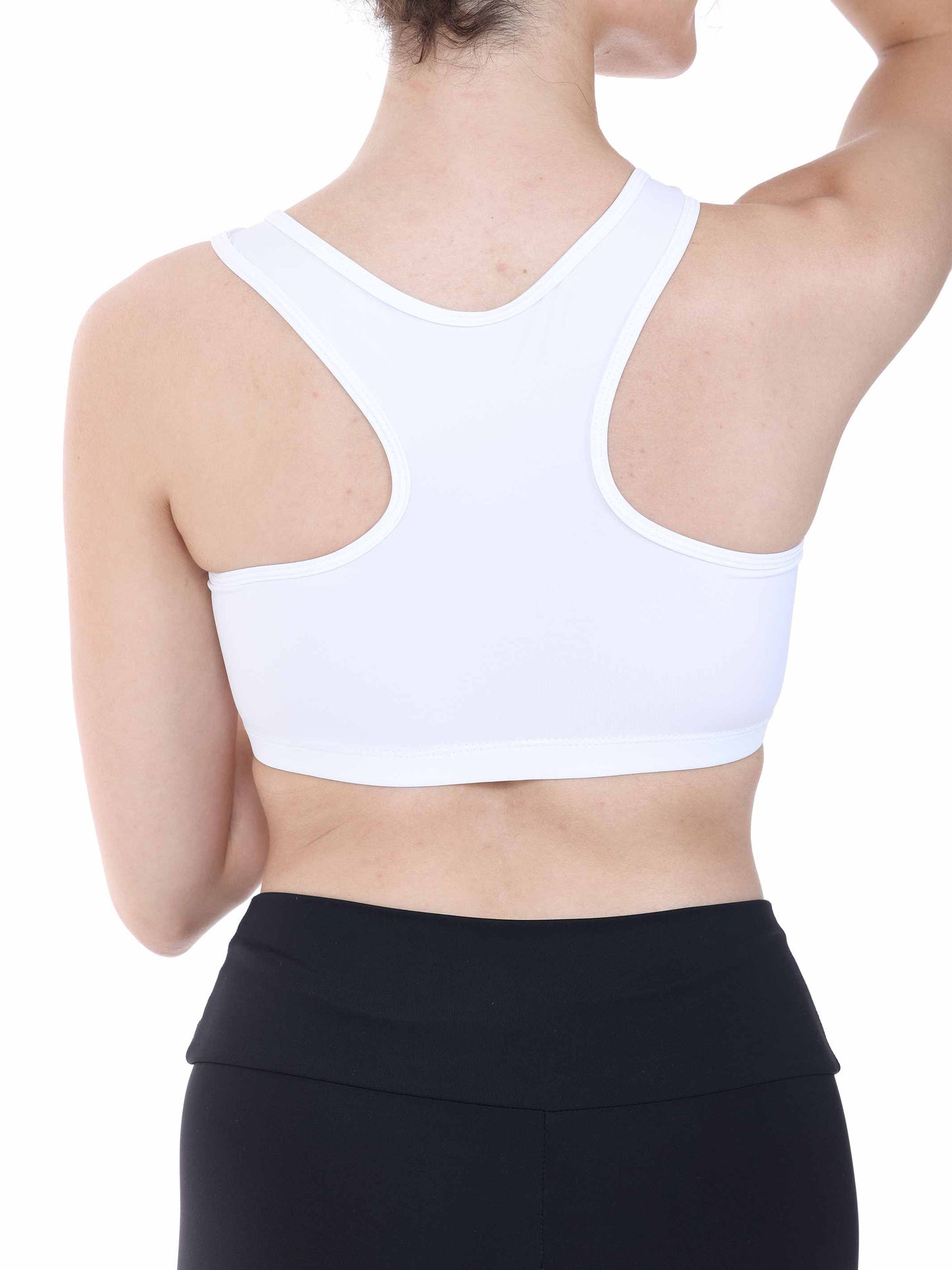 Person wearing a white sports bra and black leggings on a white background