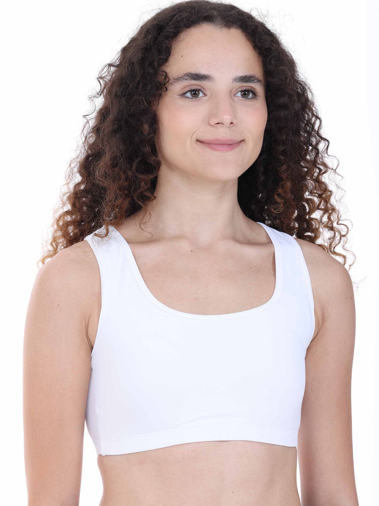 Person wearing a white sports bra against a plain background