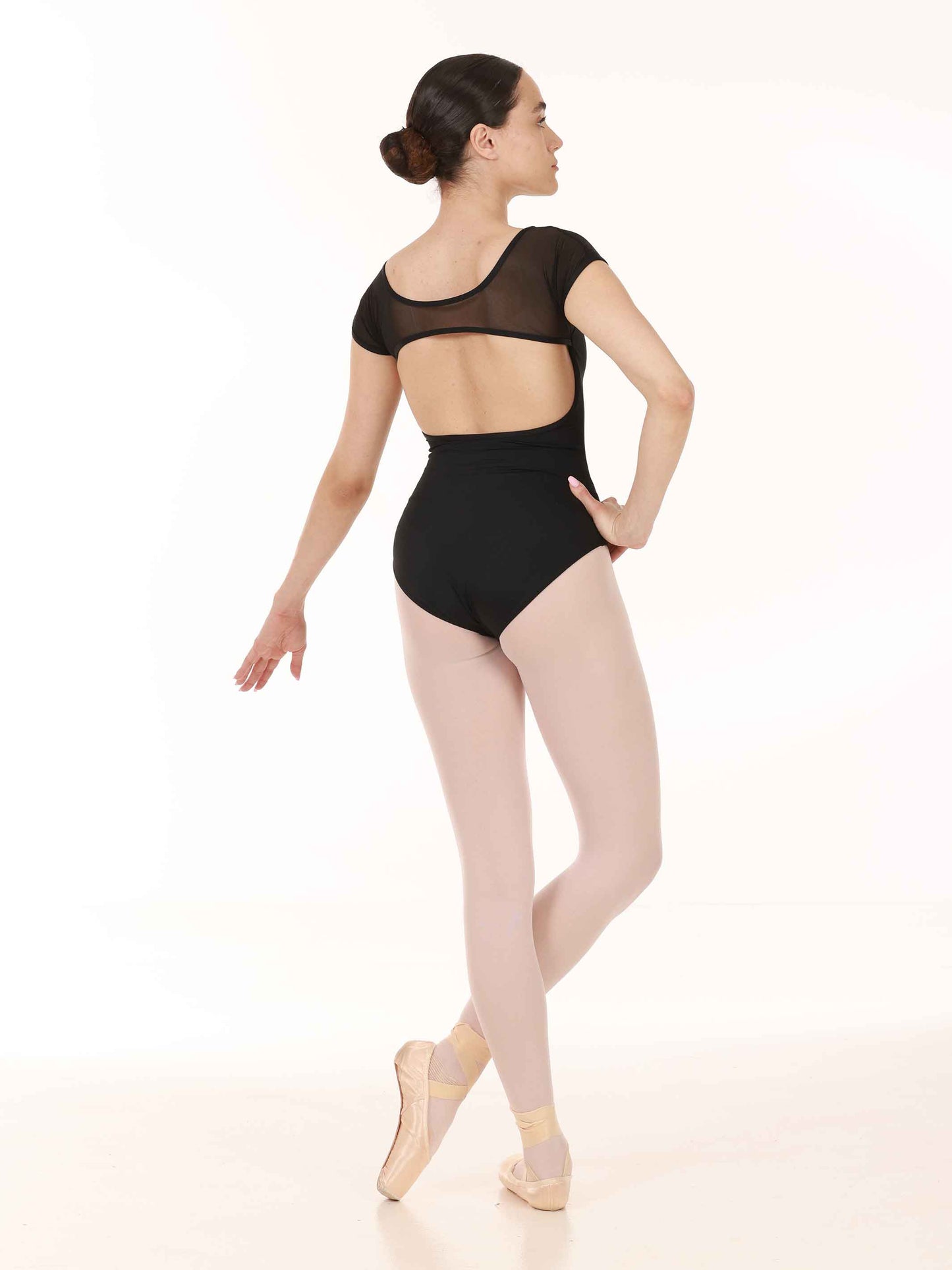 Dancer in a black leotard on a white background