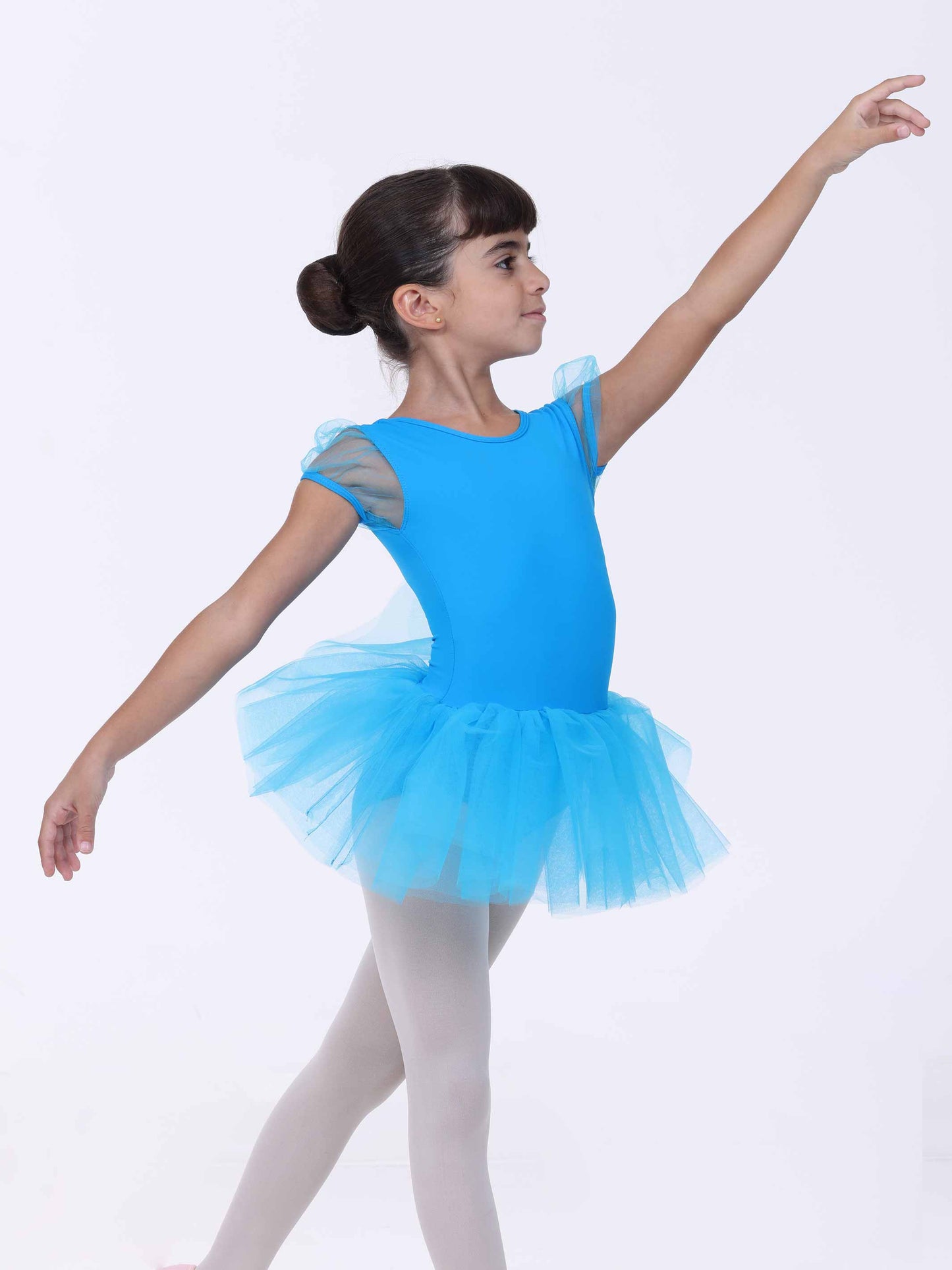 Young girl in a blue ballet outfit with a tutu on a white background