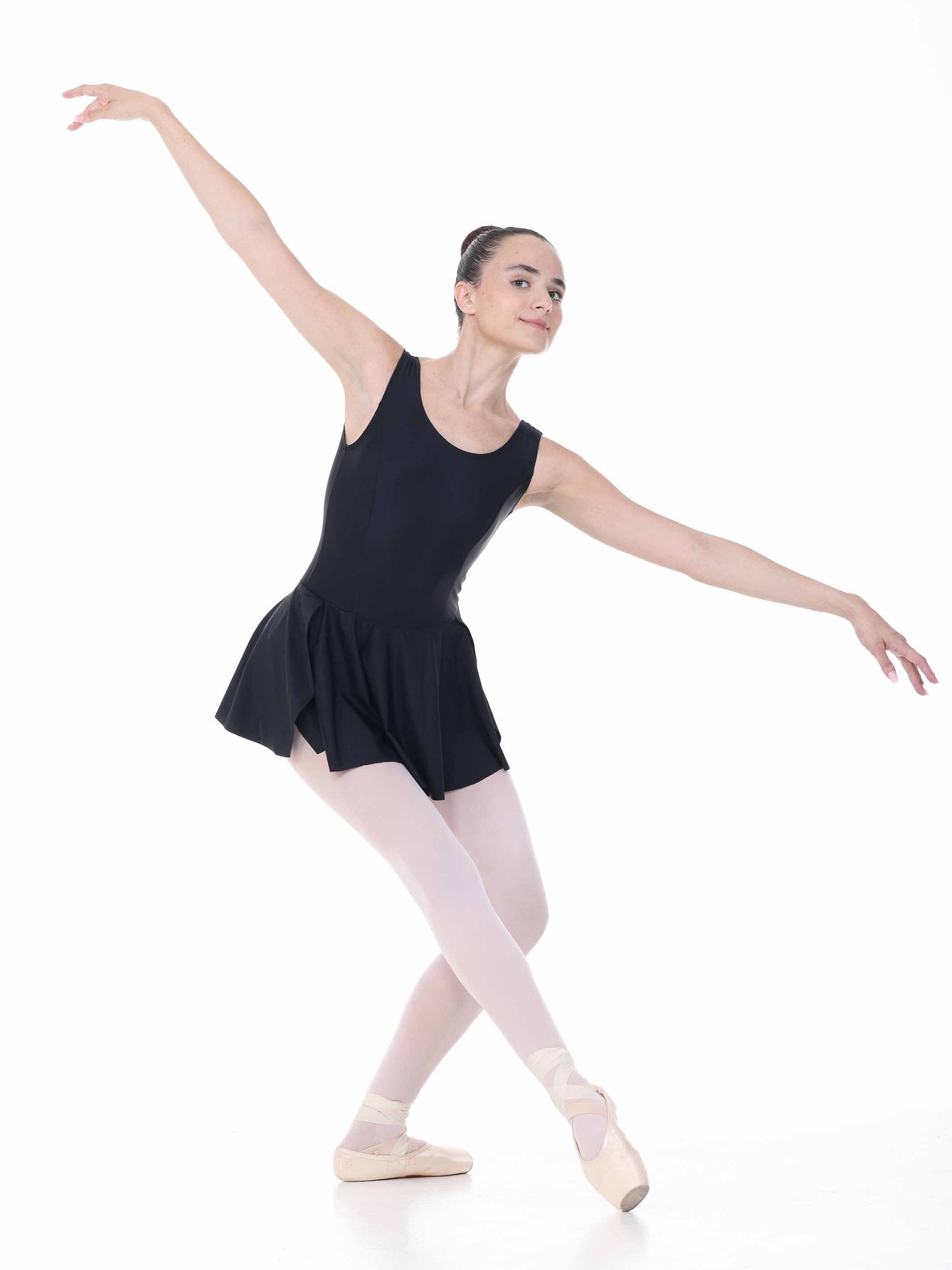 Ballerina in a black leotard and white tights posing on a white background