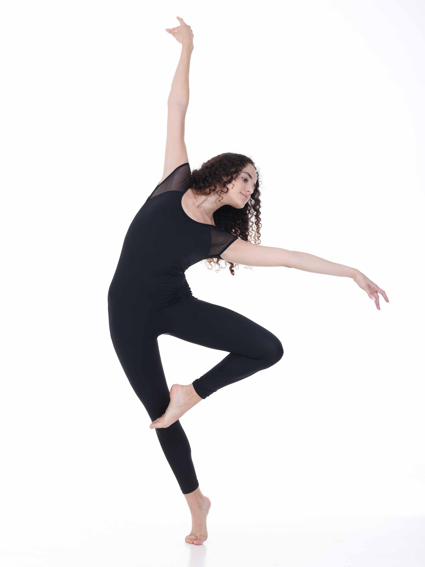 Dancer in a black outfit posing on a white background