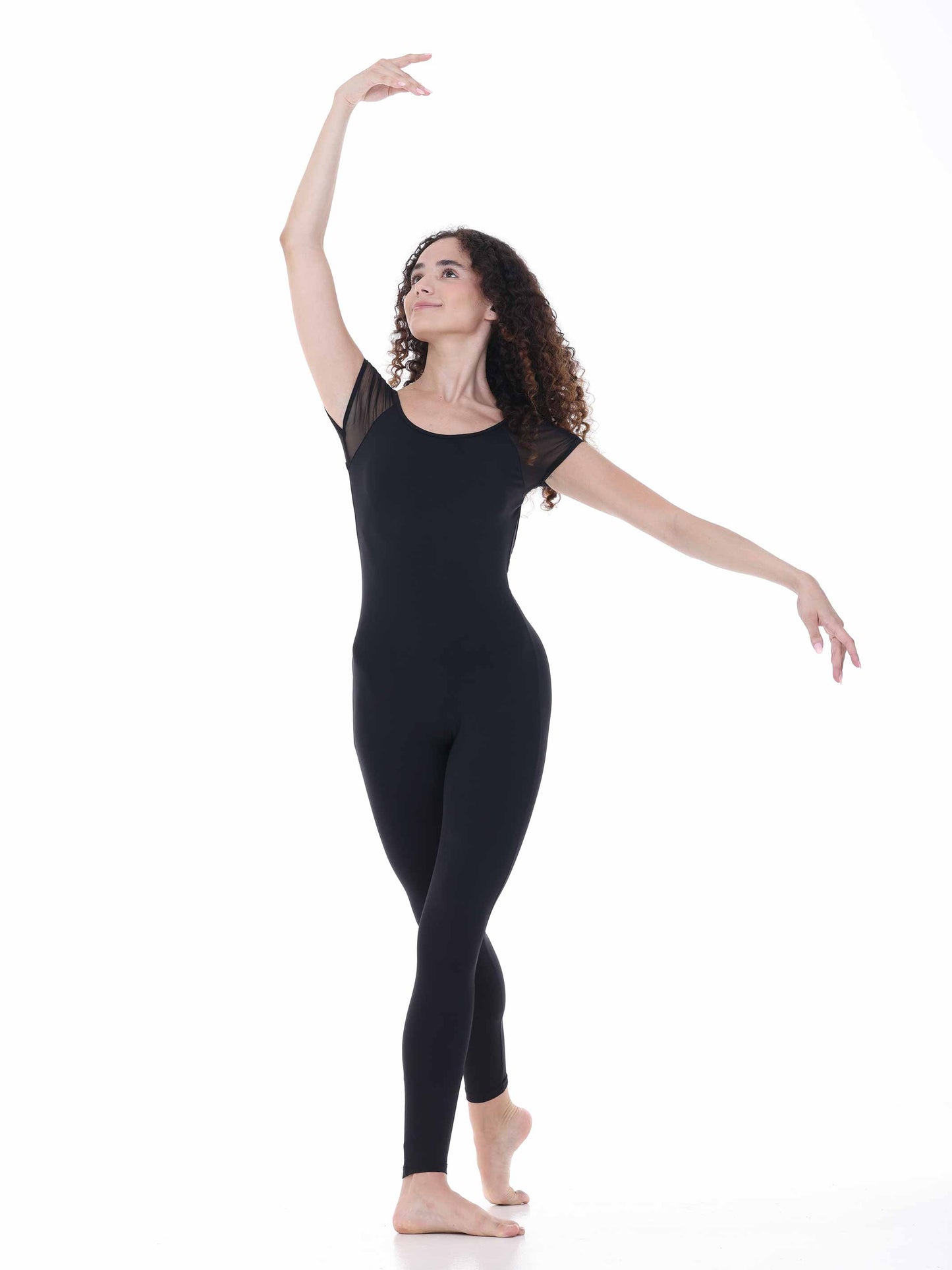 Dancer in a black unitard posing on a white background