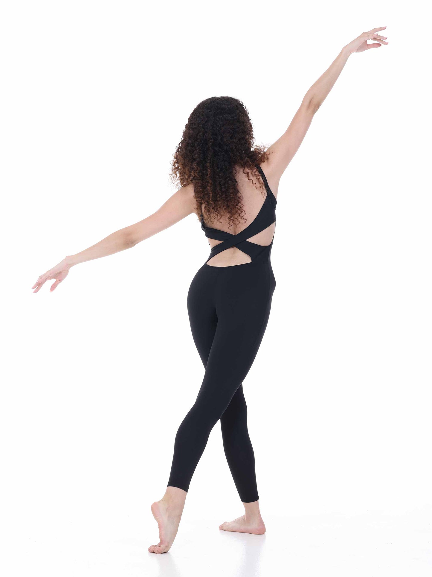 Woman wearing a black outfit with cut-out design on a white background