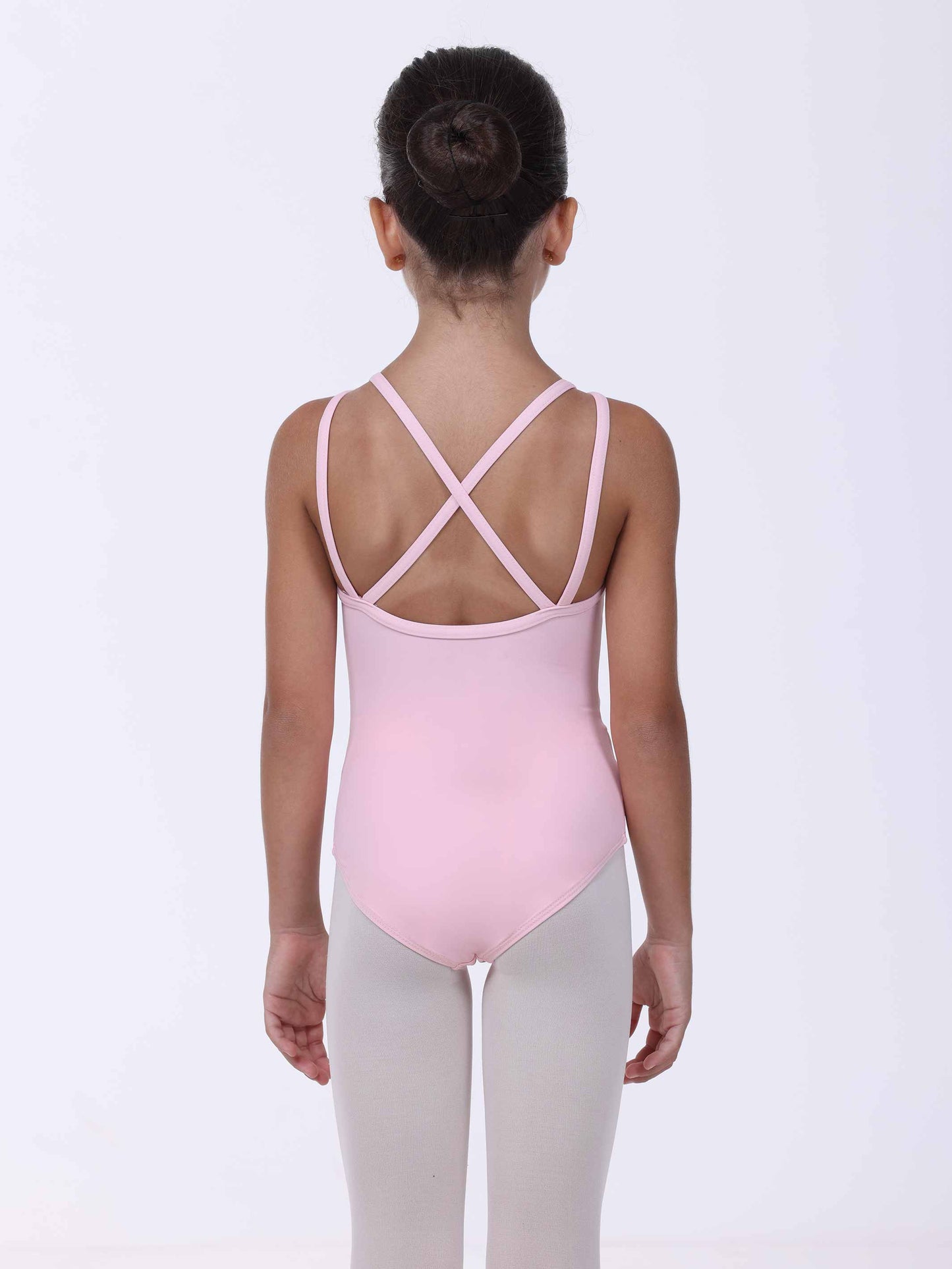 Person wearing a light pink leotard with criss-cross straps on a white background