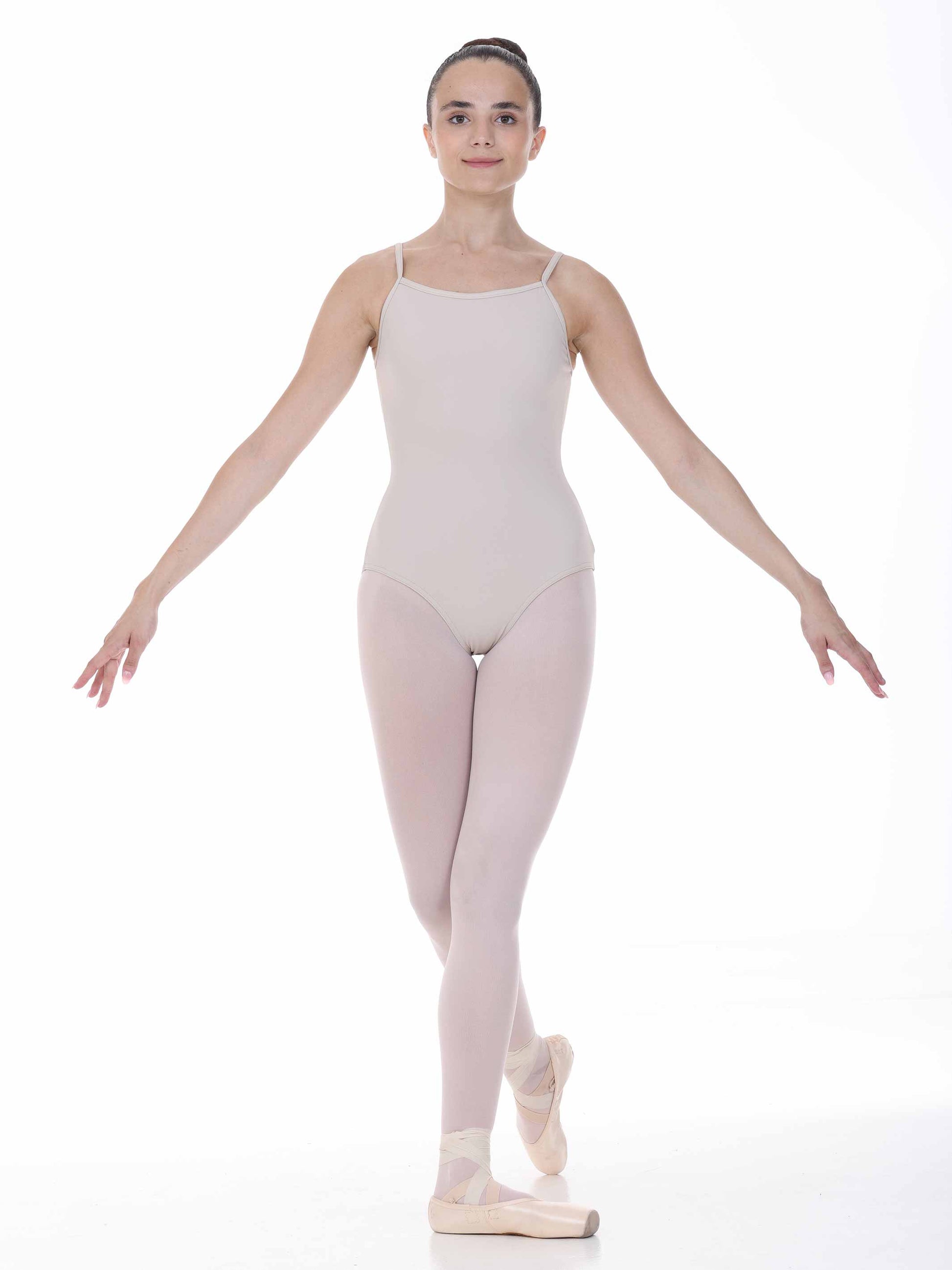 Ballerina in a nude leotard and tights on a white background
