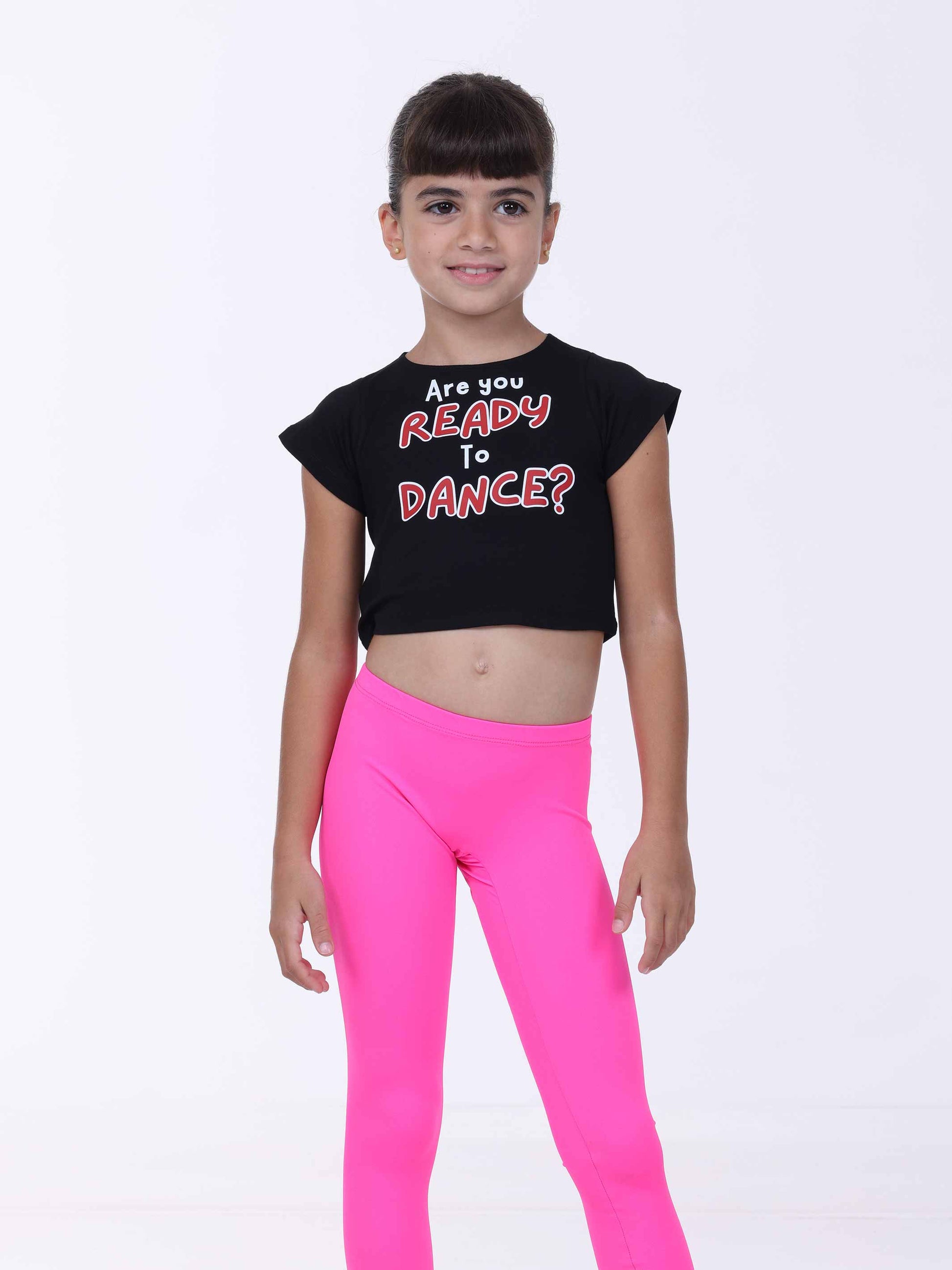 Child wearing a black crop top with 'Are you Ready to Dance?' text and pink leggings on a white background
