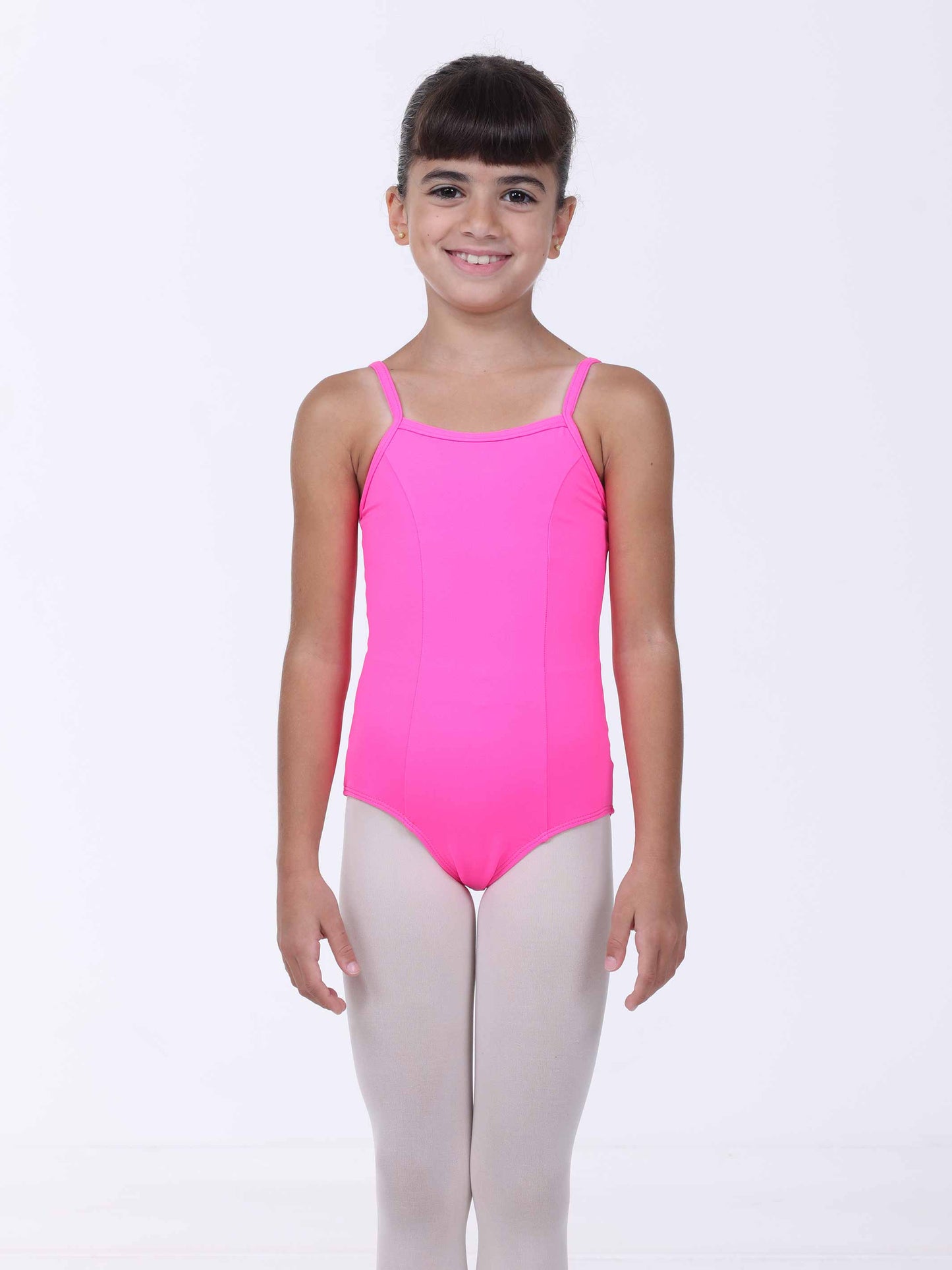 Young girl wearing a pink ballet leotard on a white background