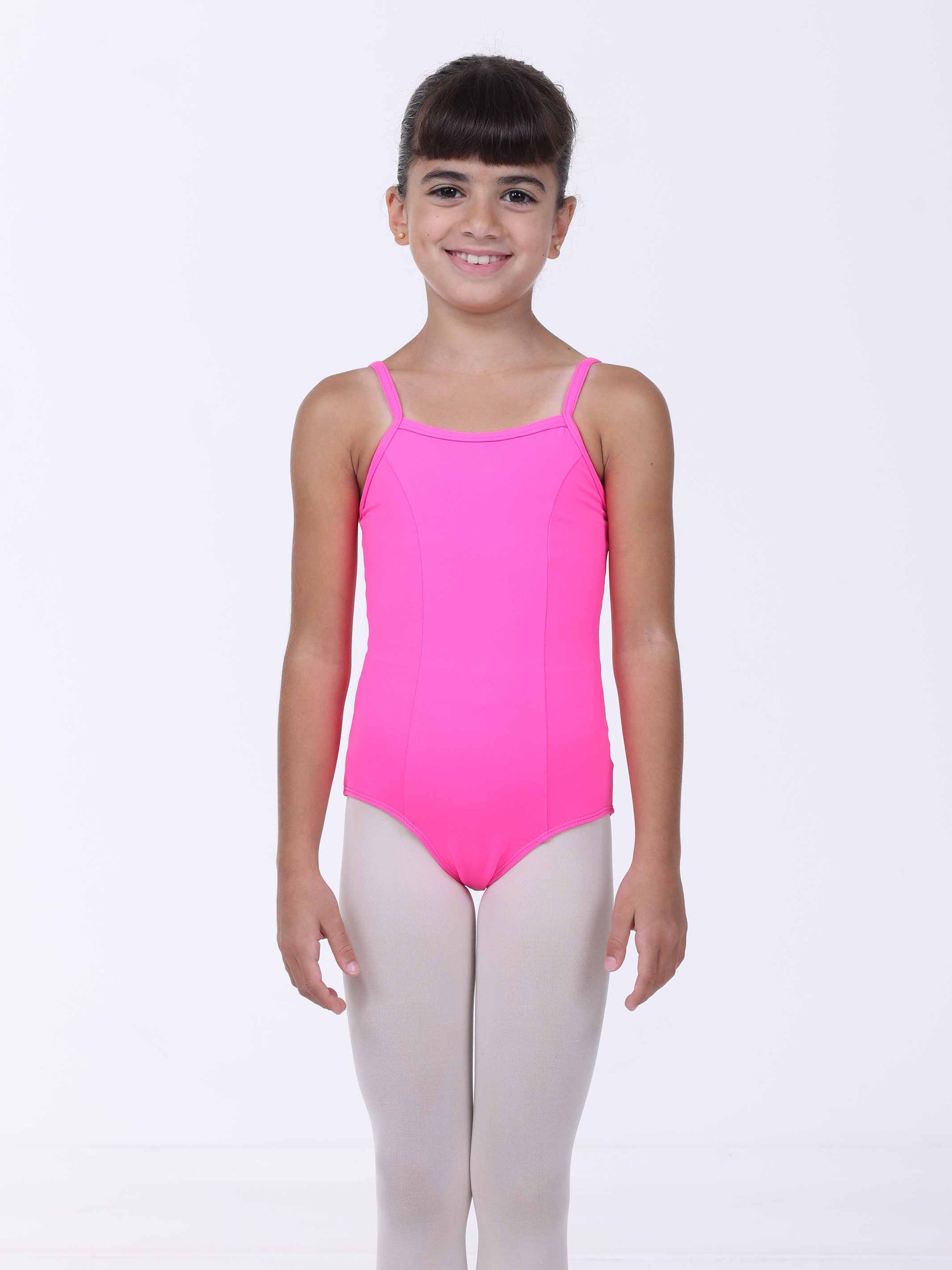Young girl wearing a pink ballet leotard on a white background