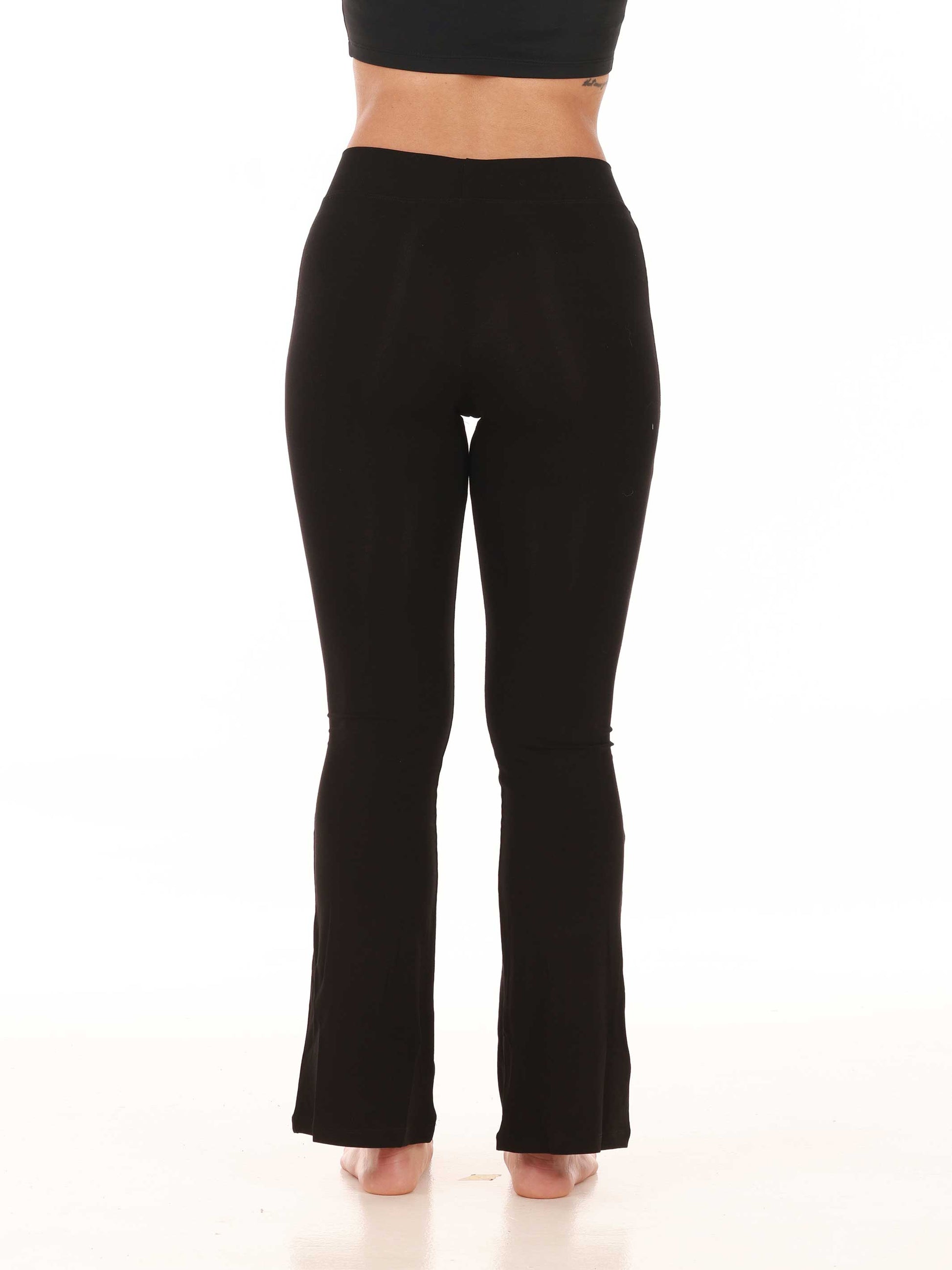 Black jazz pants worn by a person on a white background