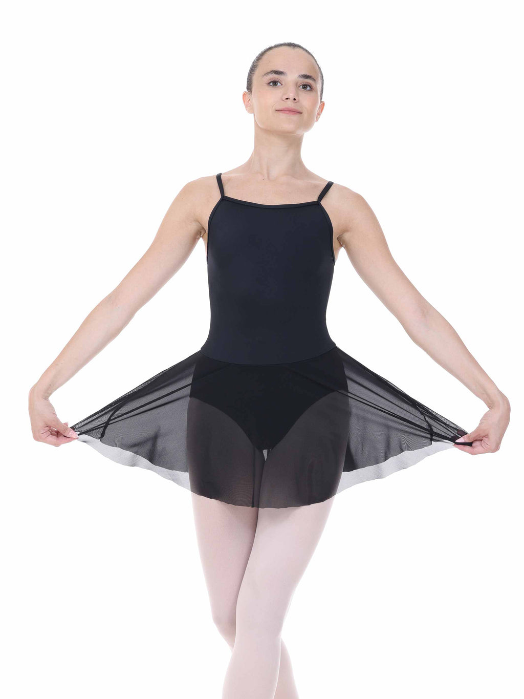Ballerina wearing a black leotard with sheer overlay on a white background
