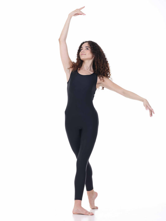 Woman in a black unitard posing on a white background