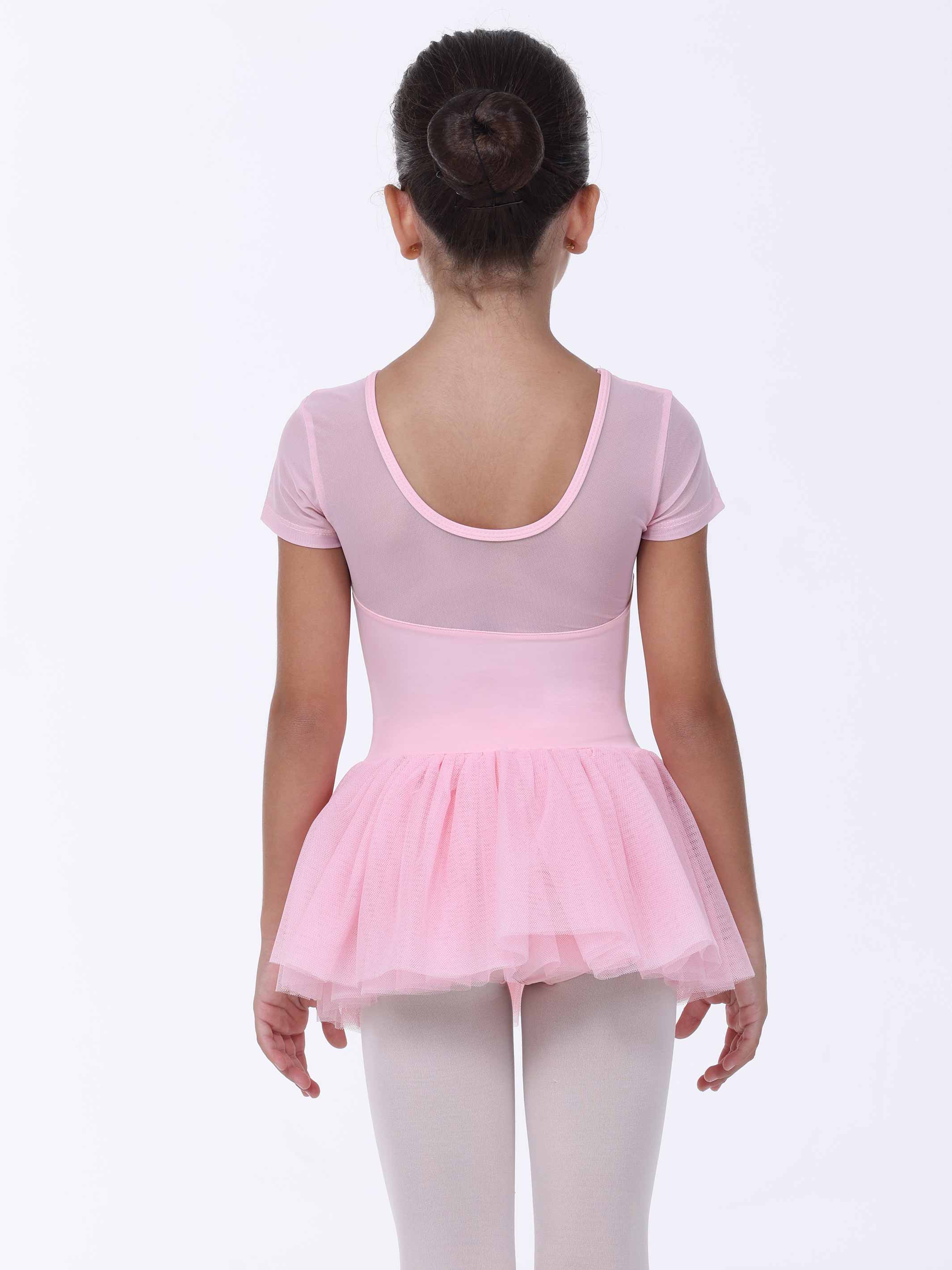 Young girl wearing a pink ballet dress on a white background