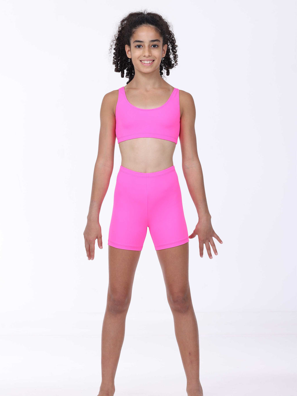 Person wearing a bright pink athletic outfit on a white background