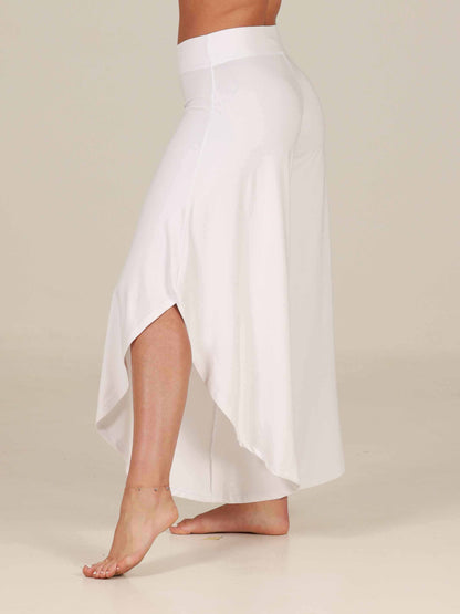 White Jazz pants worn by a dancer on a beige background