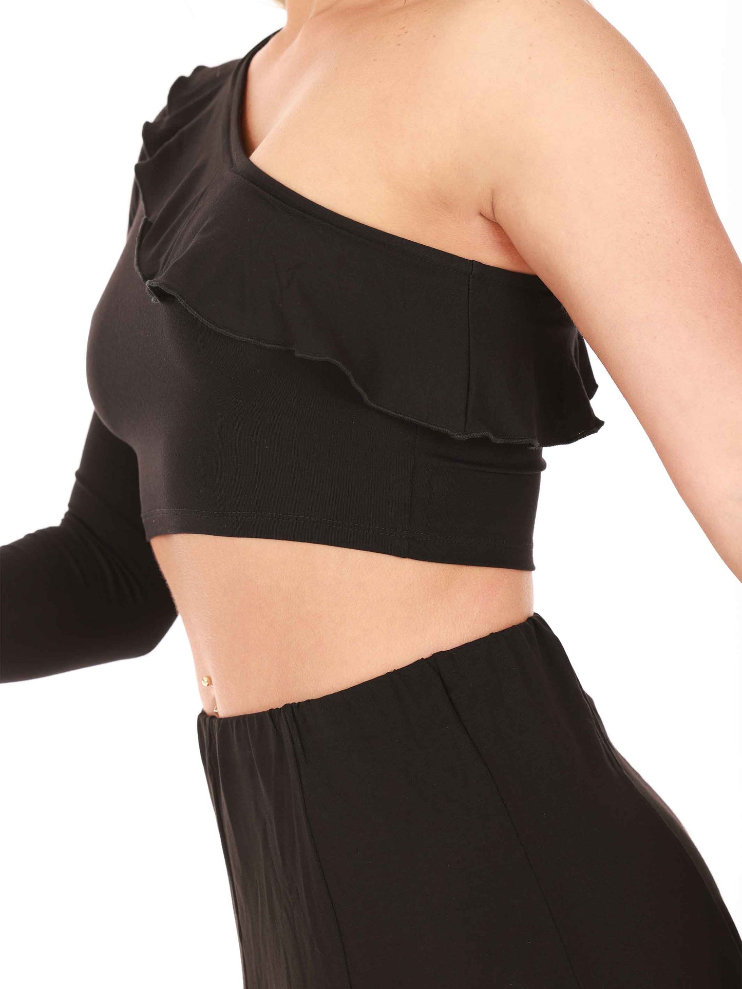 Black one-shoulder ruffled top worn by a person on a white background