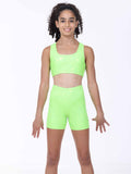 Young girl wearing a bright green athletic gymnastics outfit on a white background