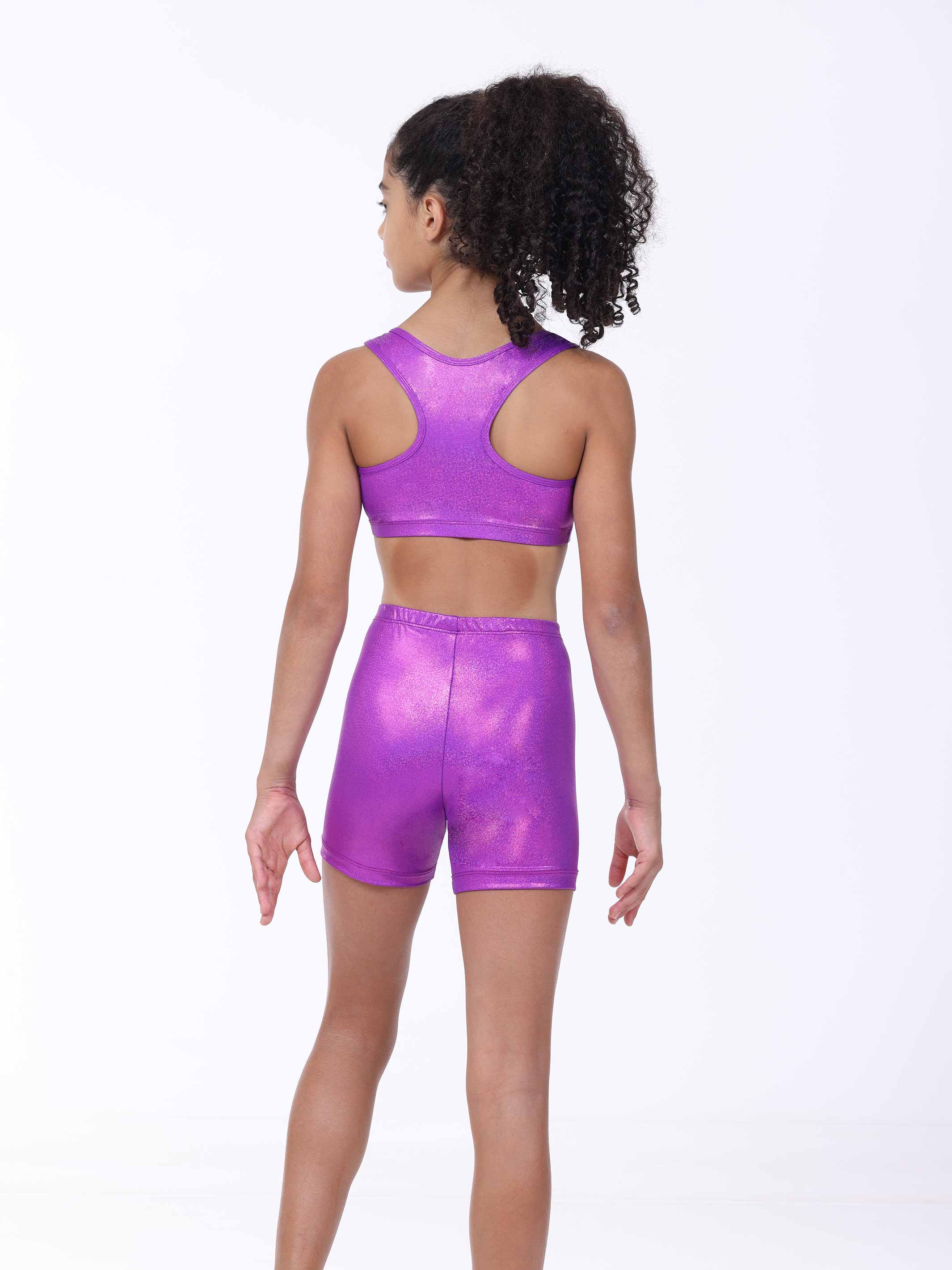 Person wearing a purple metallic sports bra and shorts on a white background