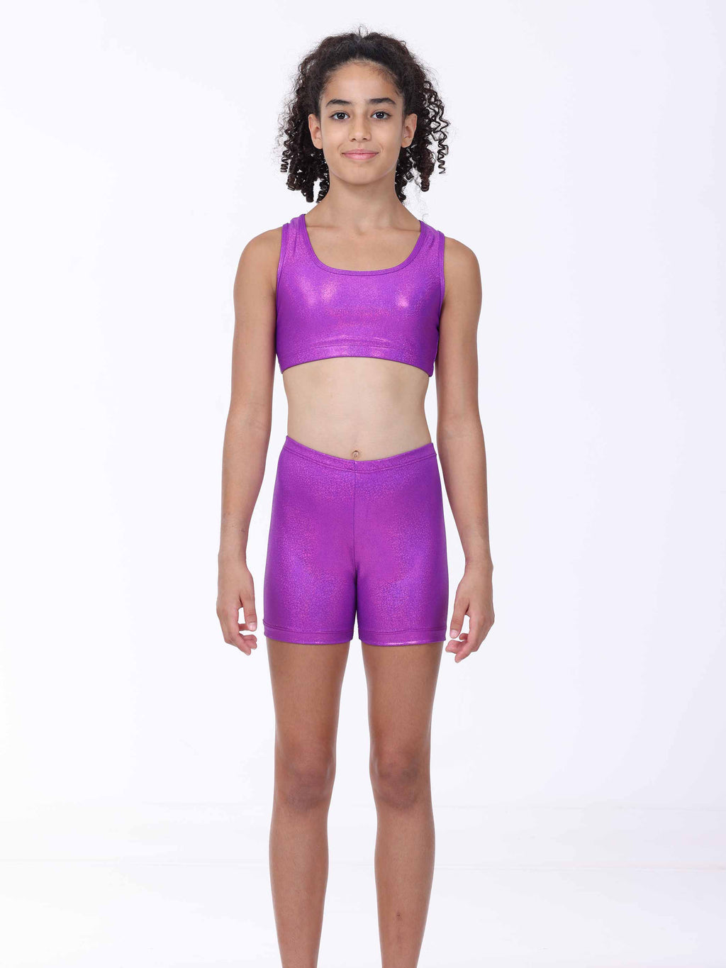 Person wearing a purple sports bra and shorts set on a white background