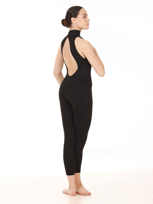 Person wearing a black bodysuit with open back on a white background