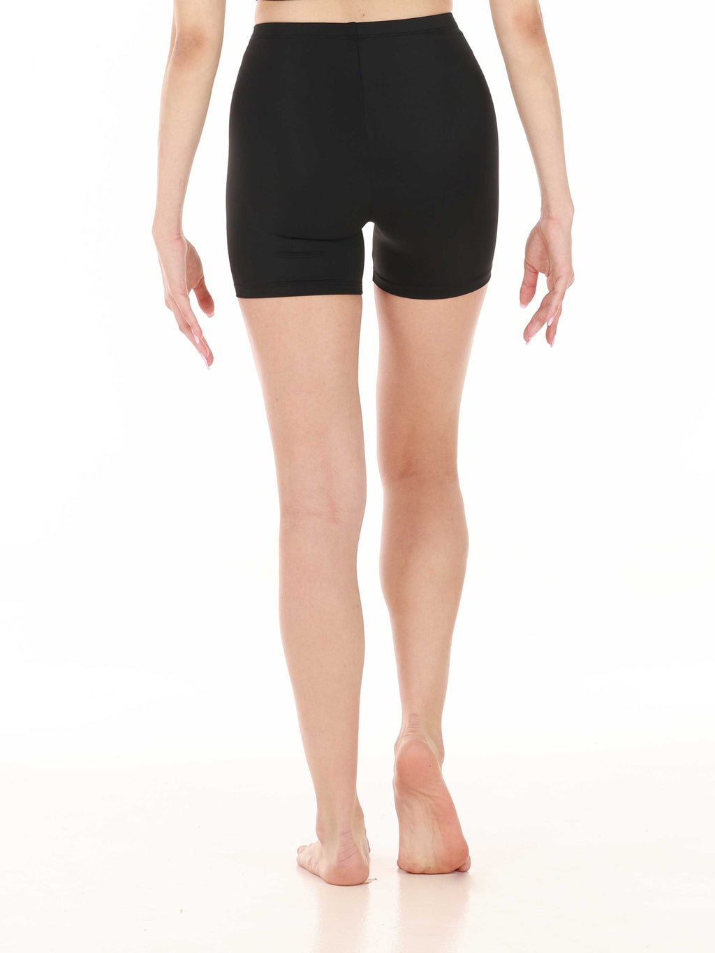 Person wearing black shorts on a white background