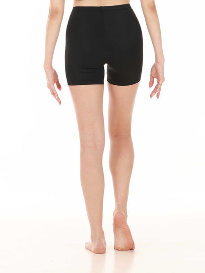 Person wearing black shorts on a white background