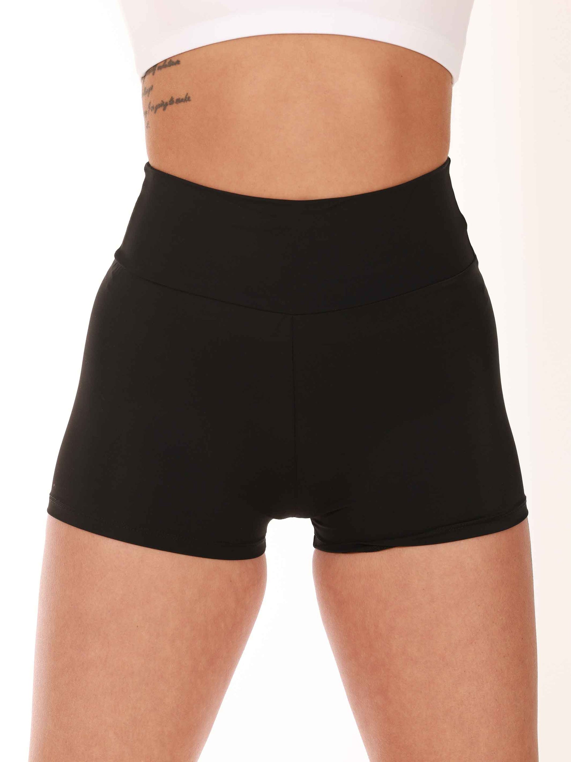Person wearing black high-waisted shorts on a white background