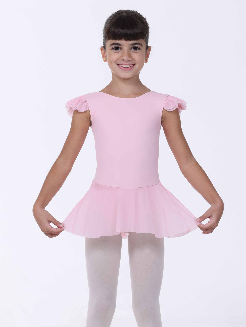 Young girl wearing a pink ballet dress with ruffled sleeves on a white background