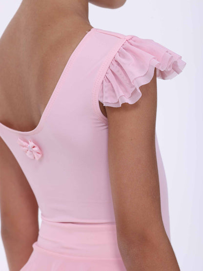 Close-up of a pink dress with ruffled details on a white background