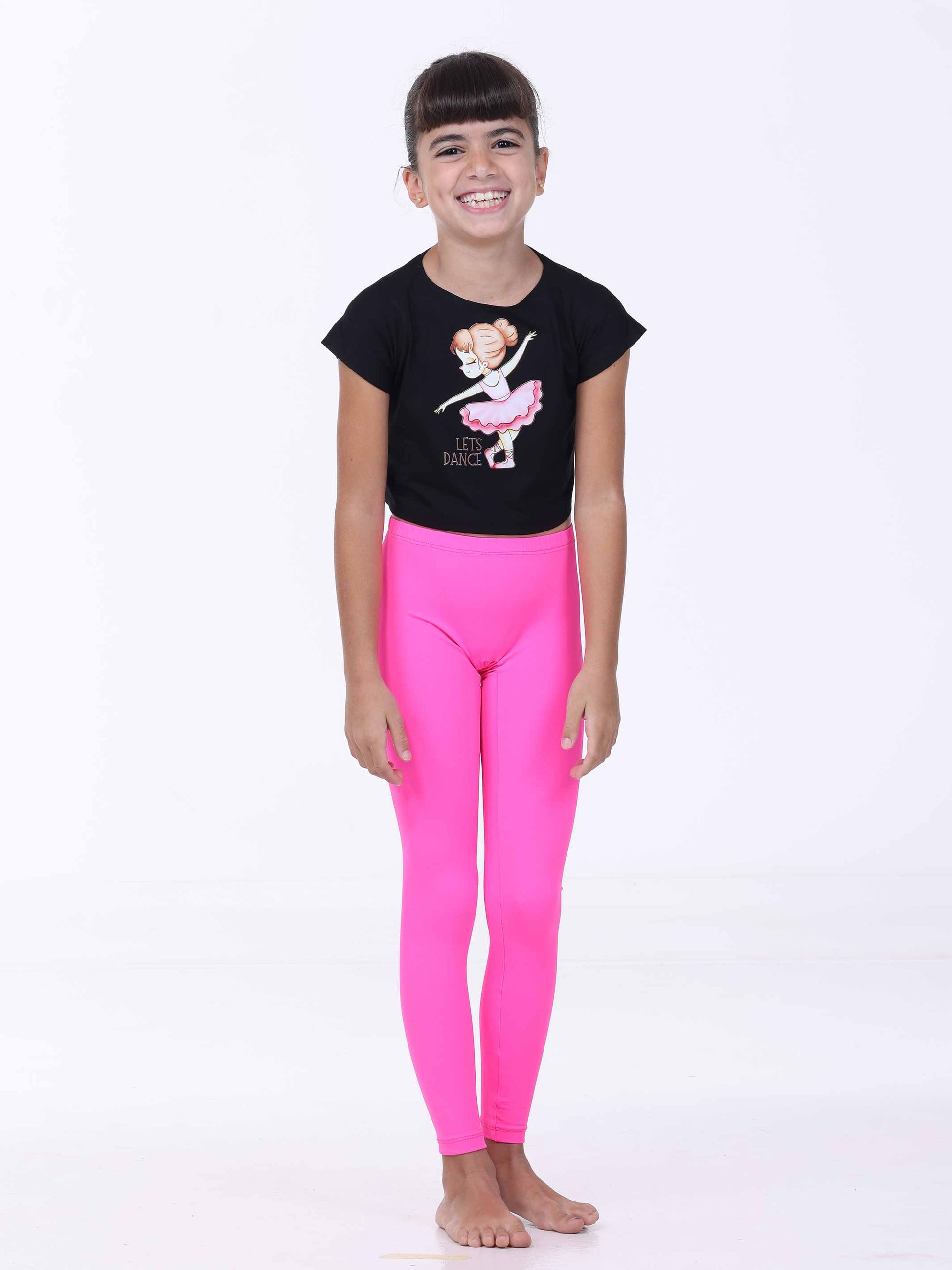 Child wearing a black t-shirt with a ballerina design and pink leggings on a white background