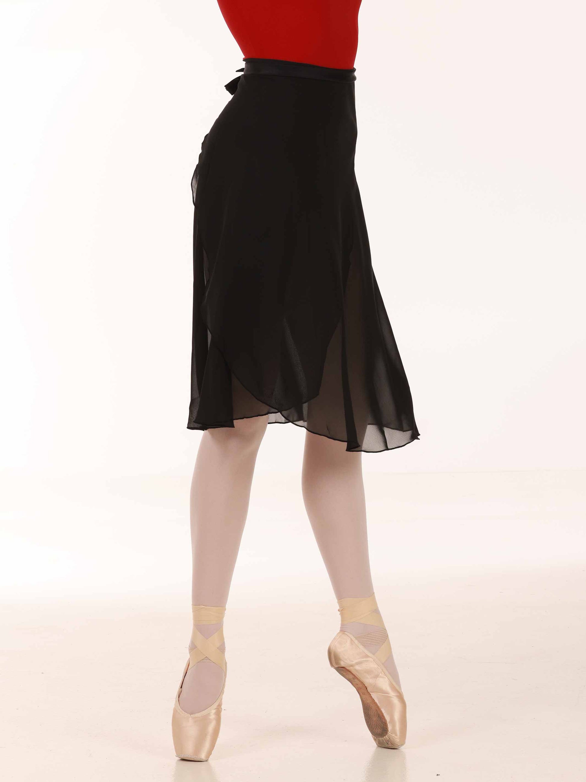 Ballerina wearing a long black chiffon skirt and red top
